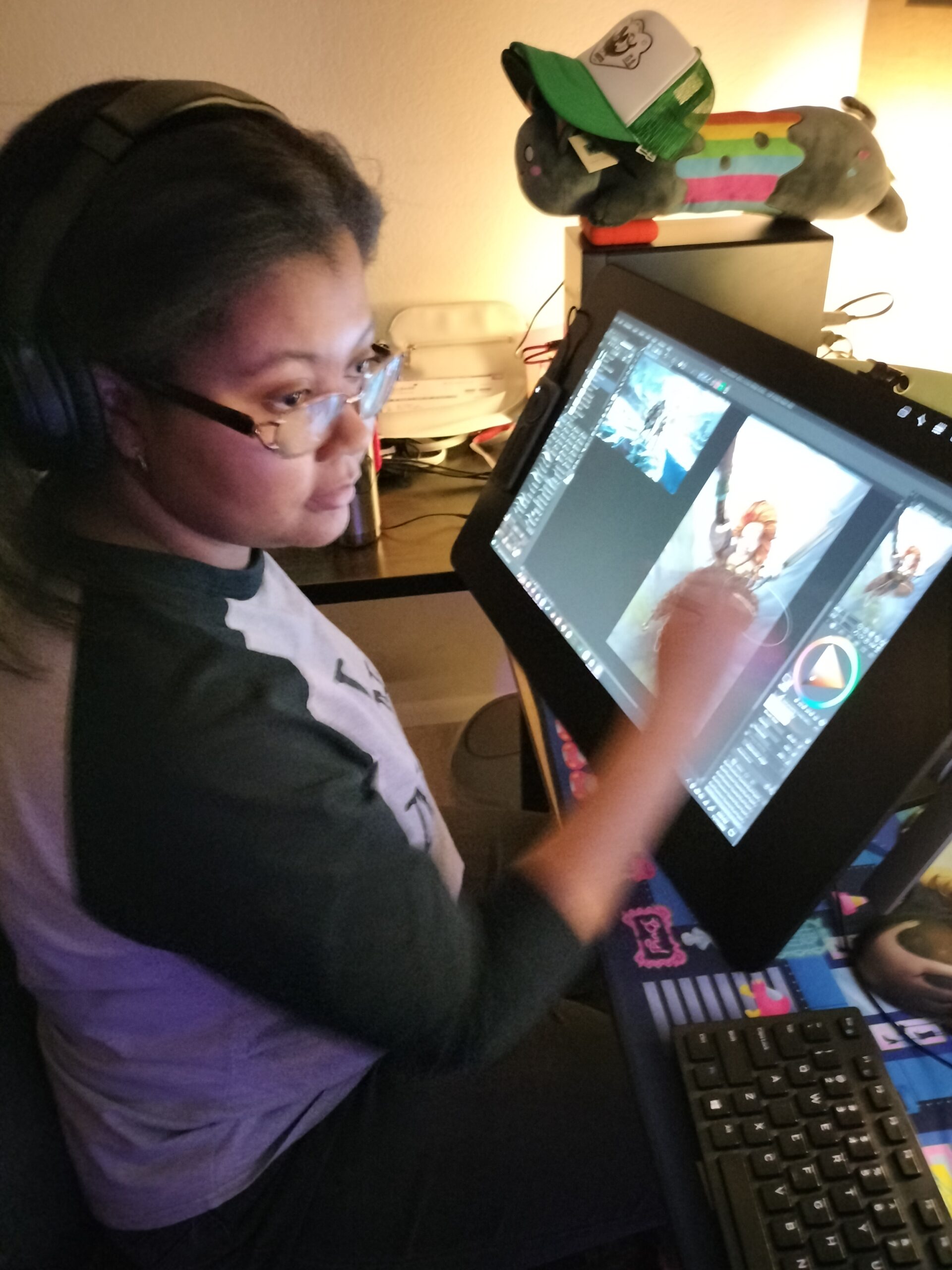 Troi creating a digital illustration with a stylus pen and a Wacom tablet.